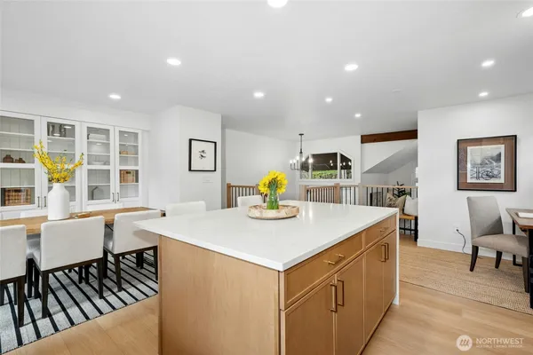 a living room with stainless steel appliances furniture a dining table chair and glass door