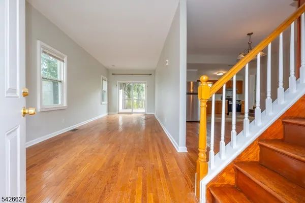 a view of an entryway with wooden floor