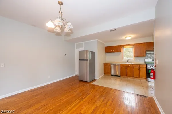 a view of a kitchen with a sink and refrigerator