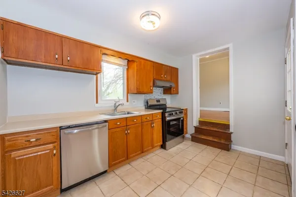 a kitchen with stainless steel appliances granite countertop a sink and cabinets