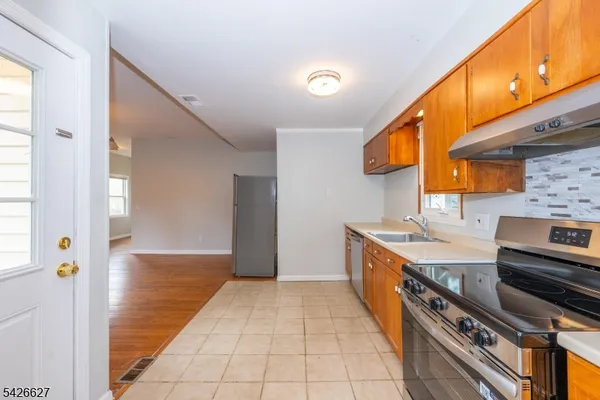 a kitchen with stainless steel appliances granite countertop a stove and a sink