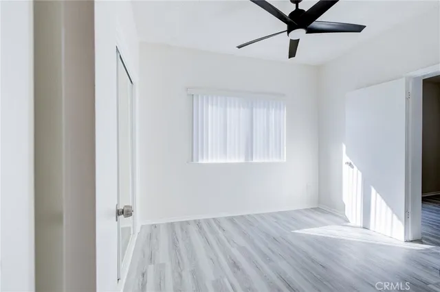 a view of a kitchen with white cabinets and black appliances