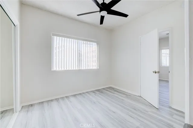 a kitchen with white cabinets a sink and dishwasher