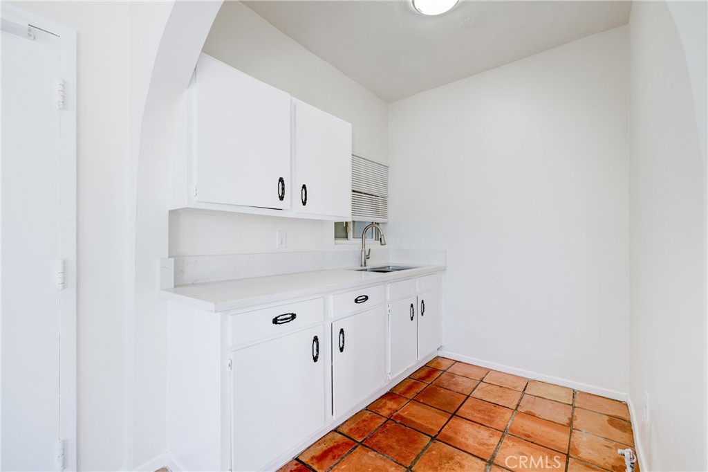 19 Wavecrest Avenue, Unit 1 Venice, CA 90291 - Photo 15 of 21 a kitchen with white cabinets a sink and dishwasher