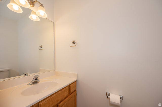 1799 West 1110th Street North Provo, UT 84604 - Photo 12 of 24 Bathroom vanity with a light wood-finish cabinet, integrated sink, and laminate countertop