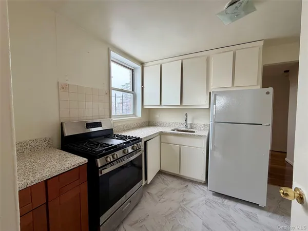 a kitchen with a stove a refrigerator and a sink