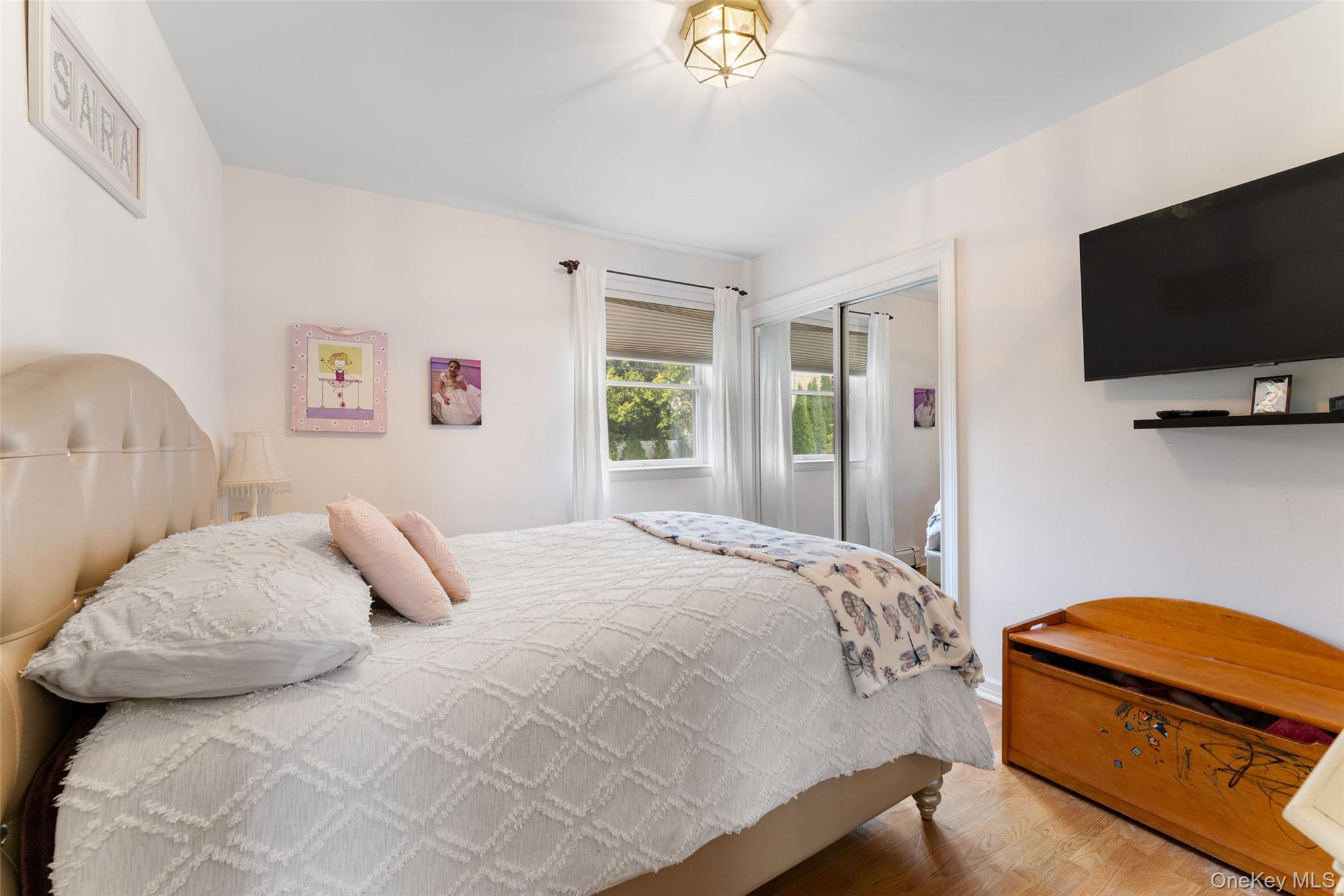 6 Hunting Ridge Road White Plains, NY 10605 - Photo 12 of 32 a bedroom with a bed and a flat screen tv