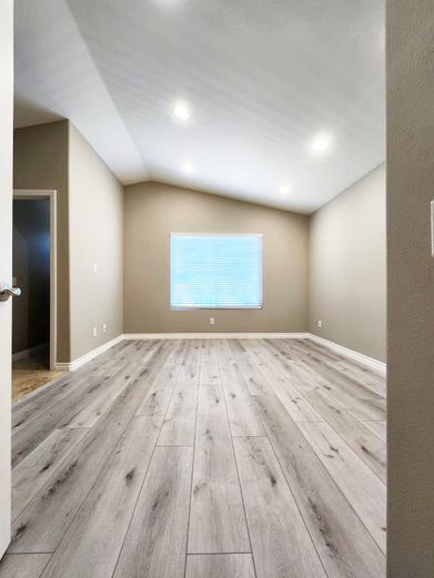 948 Bingham Drive Corona, CA 92882 - Photo 11 of 14 an empty room with wooden floor and windows