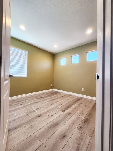 948 Bingham Drive Corona, CA 92882 - Photo 13 of 14 an empty room with wooden floor and windows