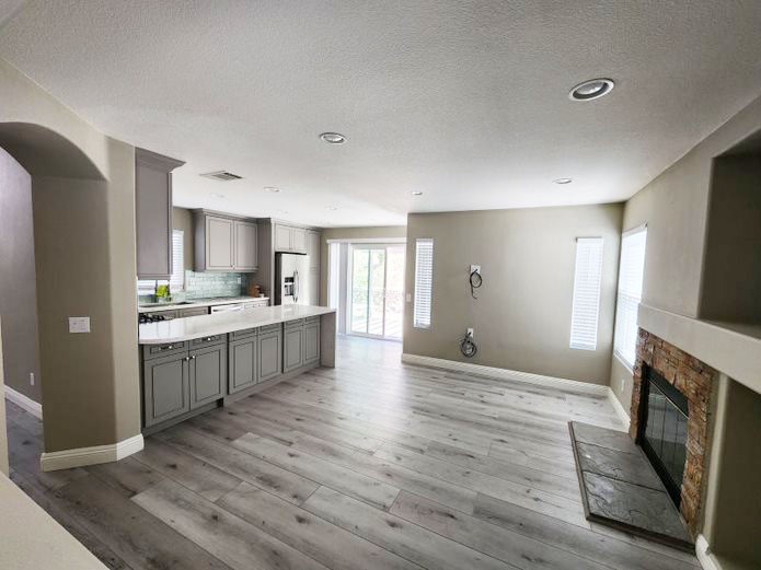 948 Bingham Drive Corona, CA 92882 - Photo 5 of 14 a large kitchen with a refrigerator a stove top oven a sink dishwasher and wooden floor