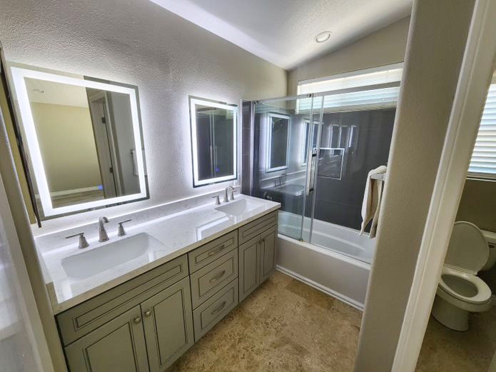 948 Bingham Drive Corona, CA 92882 - Photo 8 of 14 a bathroom with a double vanity sink toilet and shower