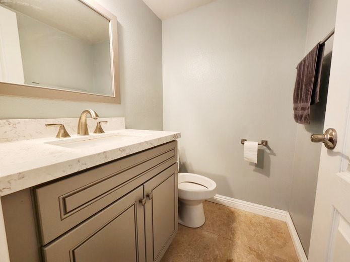 948 Bingham Drive Corona, CA 92882 - Photo 10 of 14 a bathroom with a sink toilet and mirror