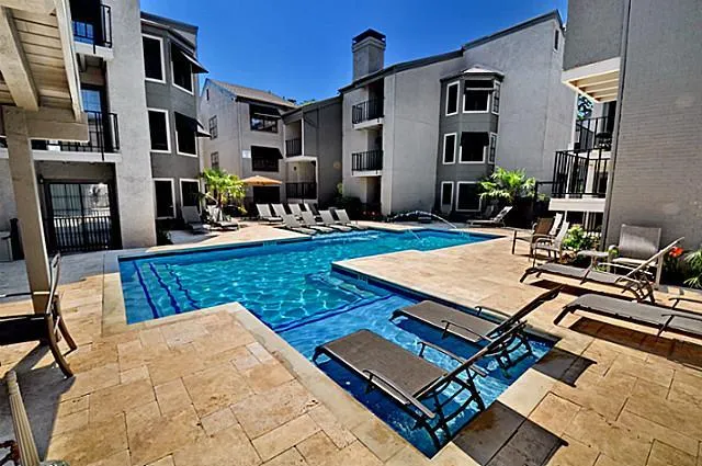 a view of a patio with dining table and chairs with wooden floor