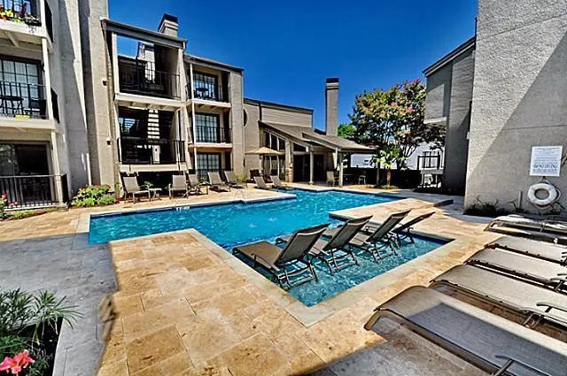 a view of a house with pool and chairs