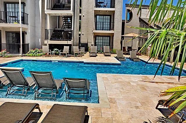 a view of a swimming pool with chairs and tables