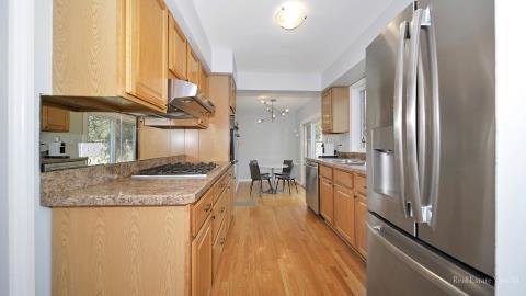 1248 Hackberry Road Deerfield, IL 60015 - Photo 14 of 40 a kitchen with stainless steel appliances granite countertop a refrigerator a sink and a stove