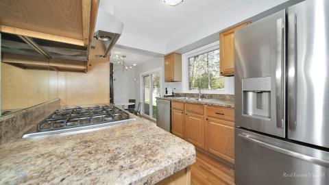 1248 Hackberry Road Deerfield, IL 60015 - Photo 15 of 40 a kitchen with stainless steel appliances granite countertop a stove a refrigerator and a refrigerator