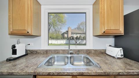 1248 Hackberry Road Deerfield, IL 60015 - Photo 16 of 40 a kitchen with granite countertop a sink and a window