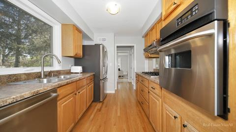 1248 Hackberry Road Deerfield, IL 60015 - Photo 17 of 40 a large kitchen with stainless steel appliances granite countertop a lot of counter space and a large window