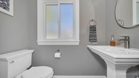 1248 Hackberry Road Deerfield, IL 60015 - Photo 20 of 40 a bathroom with a sink a toilet and a mirror