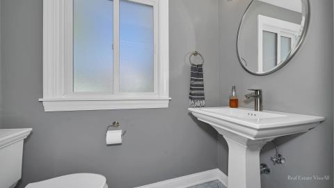 1248 Hackberry Road Deerfield, IL 60015 - Photo 21 of 40 a bathroom with a sink a mirror and a toilet