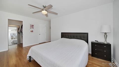 1248 Hackberry Road Deerfield, IL 60015 - Photo 23 of 40 a bedroom with a bed and wooden floor