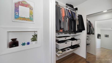 1248 Hackberry Road Deerfield, IL 60015 - Photo 24 of 40 a view of walk in closet with clothes and shoes