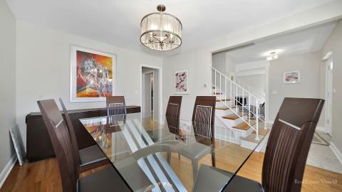 1248 Hackberry Road Deerfield, IL 60015 - Photo 10 of 40 a view of a dining room with furniture a chandelier and wooden floor