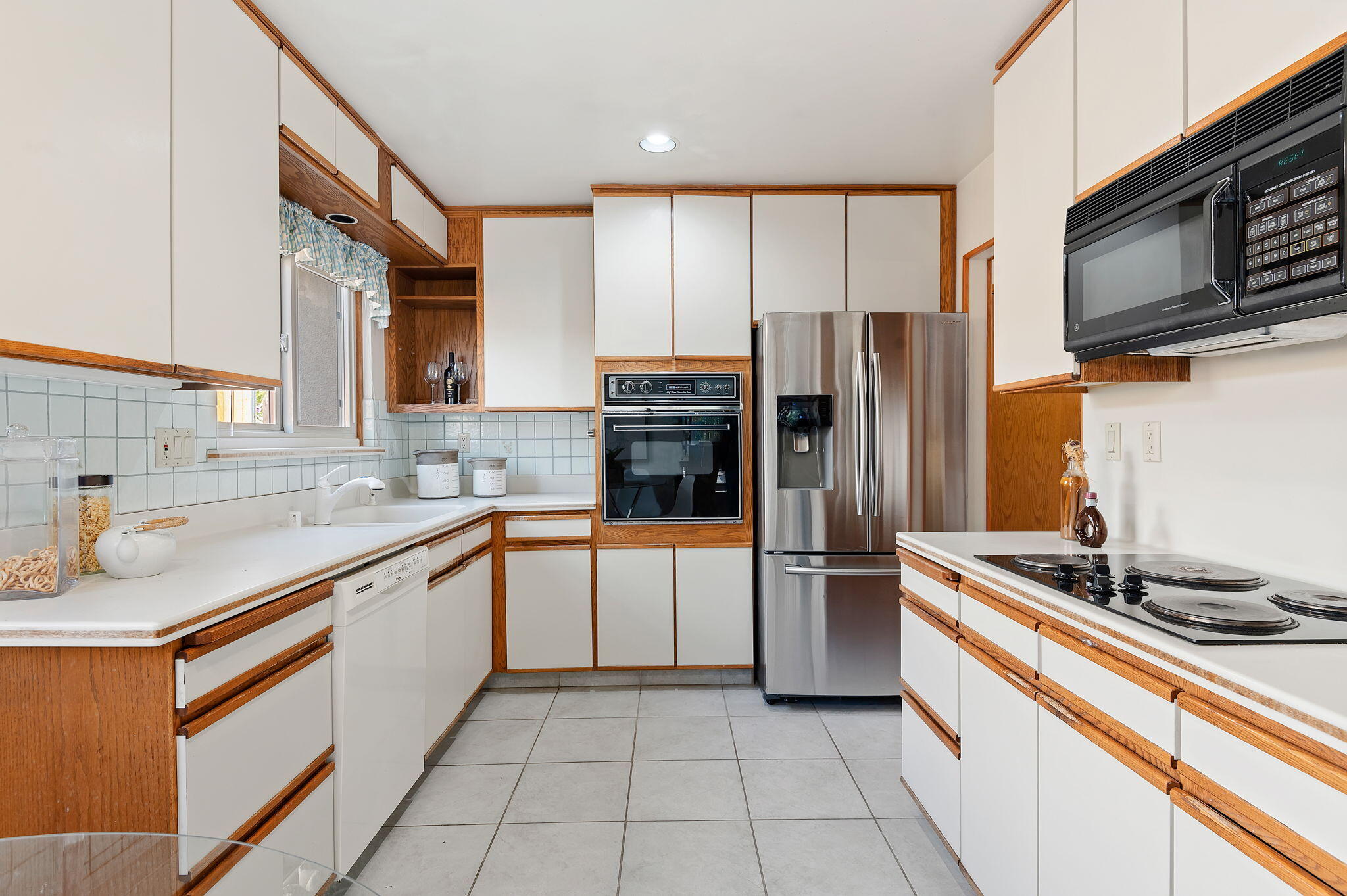 7397 Mirano Drive Goleta, CA 93117 - Photo 11 of 27 a kitchen with stainless steel appliances granite countertop a refrigerator and a sink