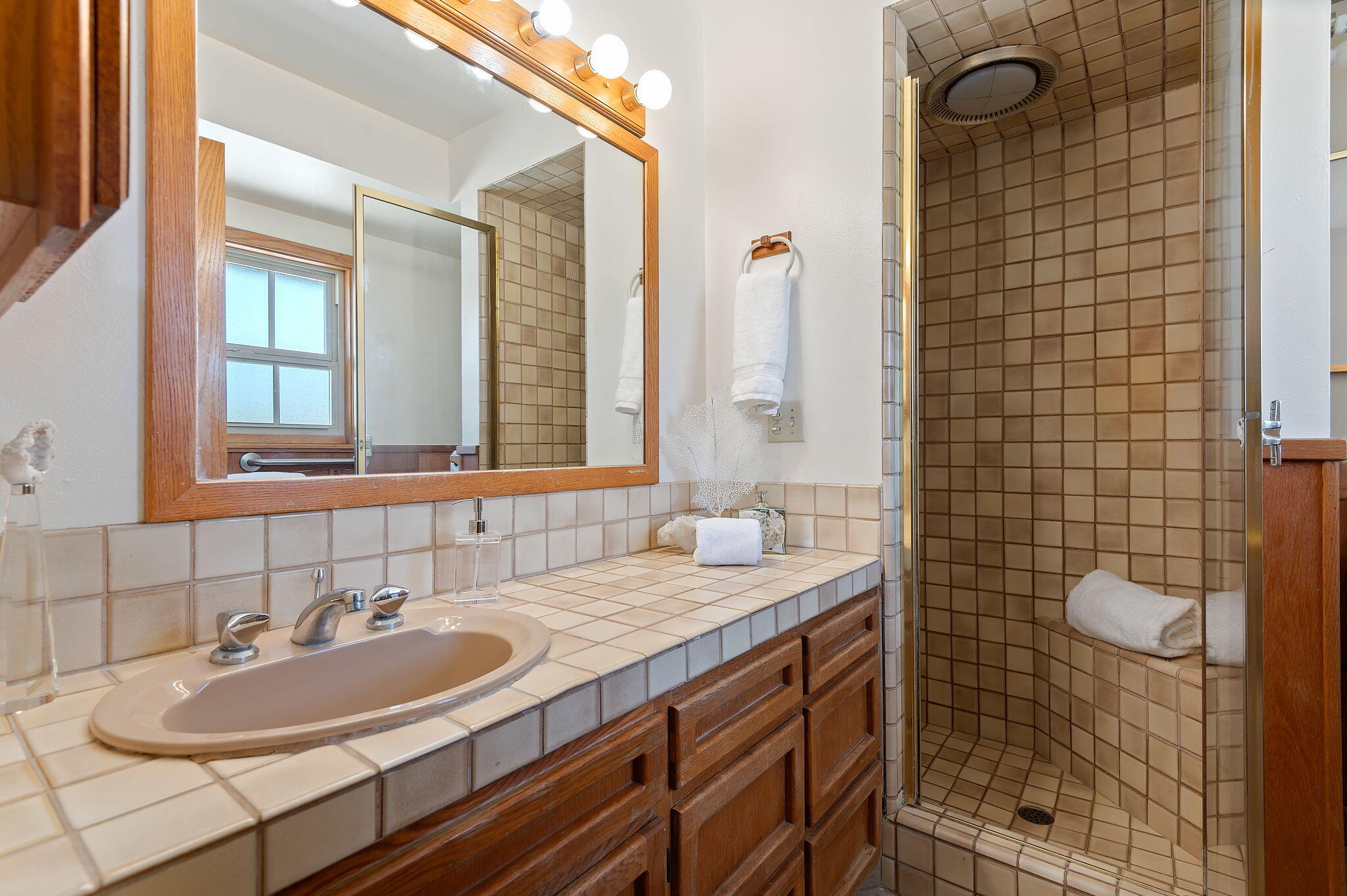 7397 Mirano Drive Goleta, CA 93117 - Photo 16 of 27 a bathroom with a sink shower vanity and a mirror