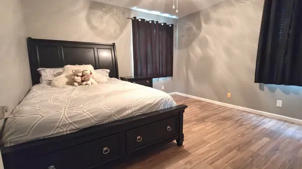 a bedroom with a bed and a large mirror
