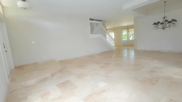 an empty room with windows and mirror