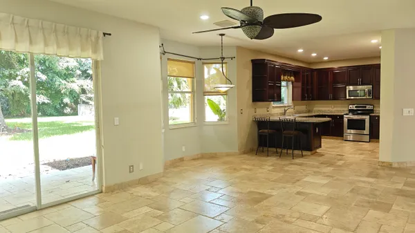 a view of kitchen with window and ceiling fan