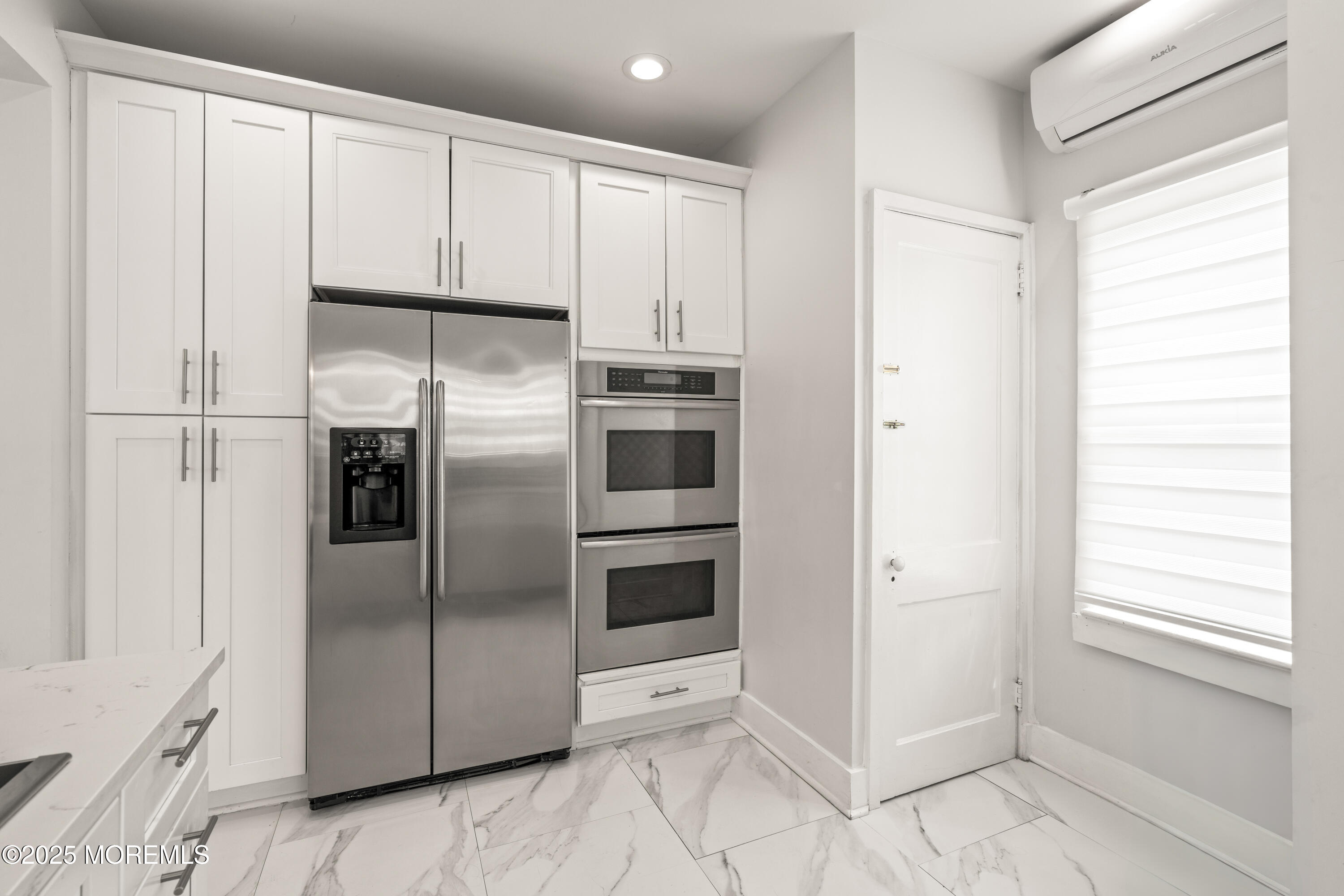 3 Reid Street Long Branch, NJ 07740 - Photo 9 of 54 a view of a refrigerator in kitchen and white cabinets