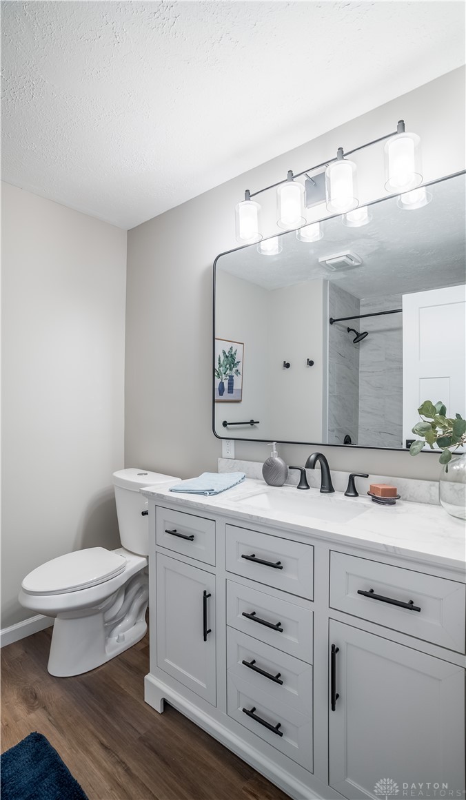 8240 Looney Road Piqua, OH 45356 - Photo 20 of 49 This bright bathroom features a spacious vanity with elegant finishes and a classic mirror.