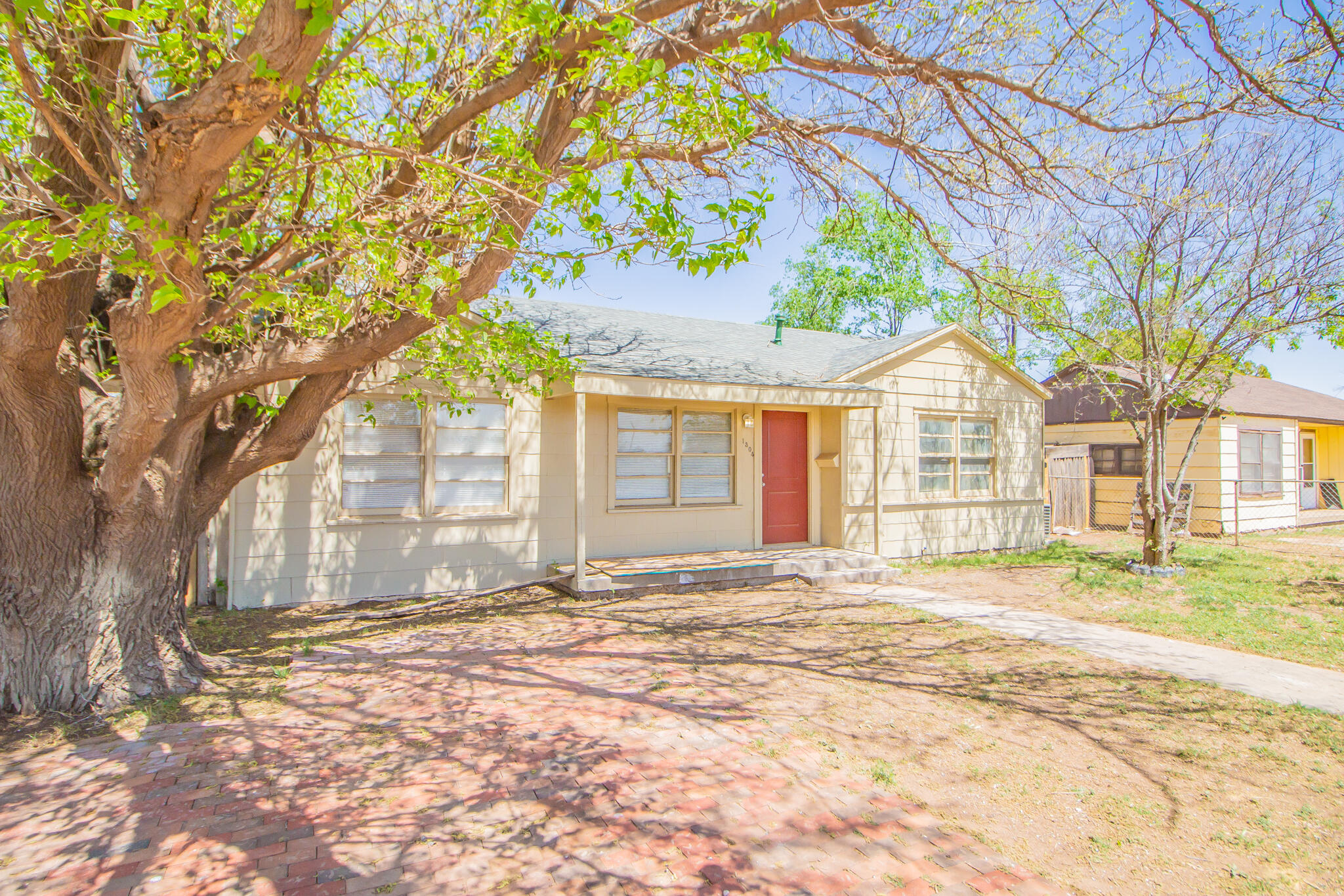 a view of a house with a tree in front