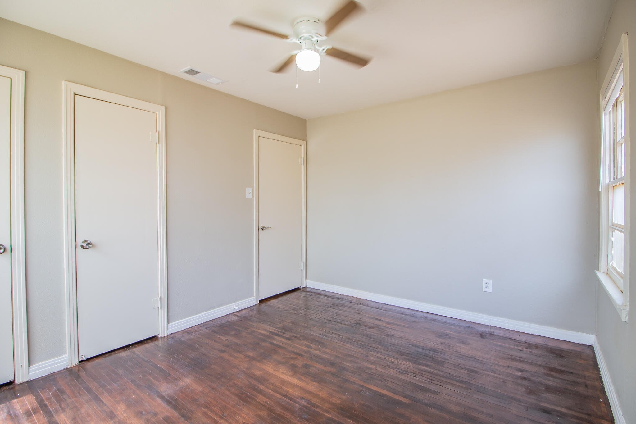 1304 42nd Street Lubbock, TX 79412 - Photo 12 of 17 wooden floor in an empty room with a window