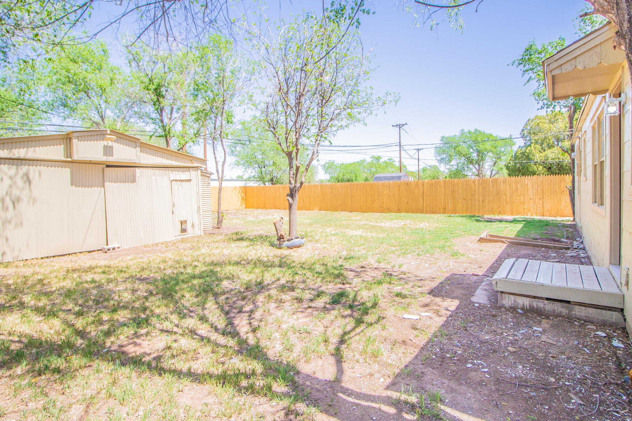 1304 42nd Street Lubbock, TX 79412 - Photo 15 of 17 a view of a backyard with a garden and tree