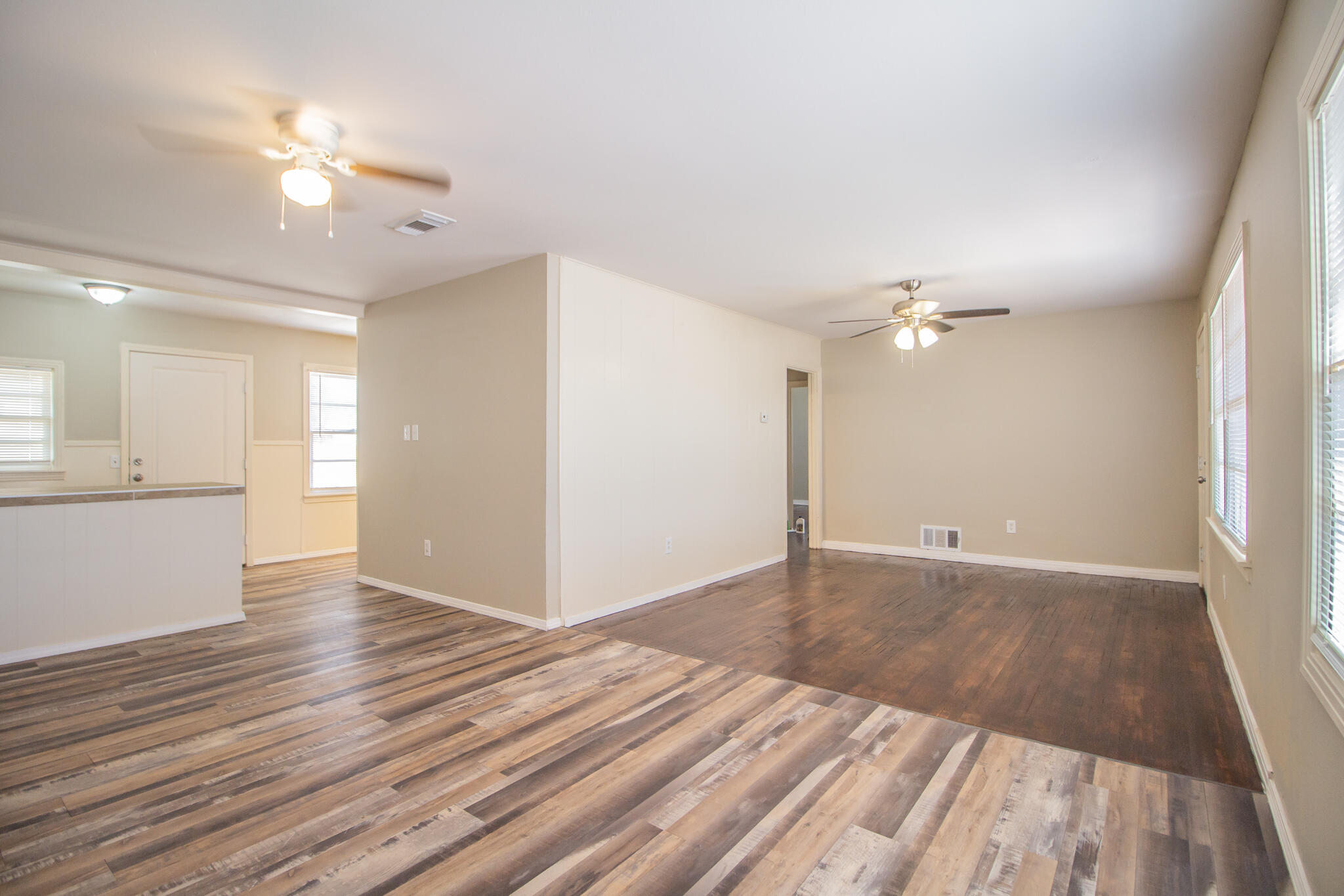 1304 42nd Street Lubbock, TX 79412 - Photo 3 of 17 wooden floor in an empty room with a window