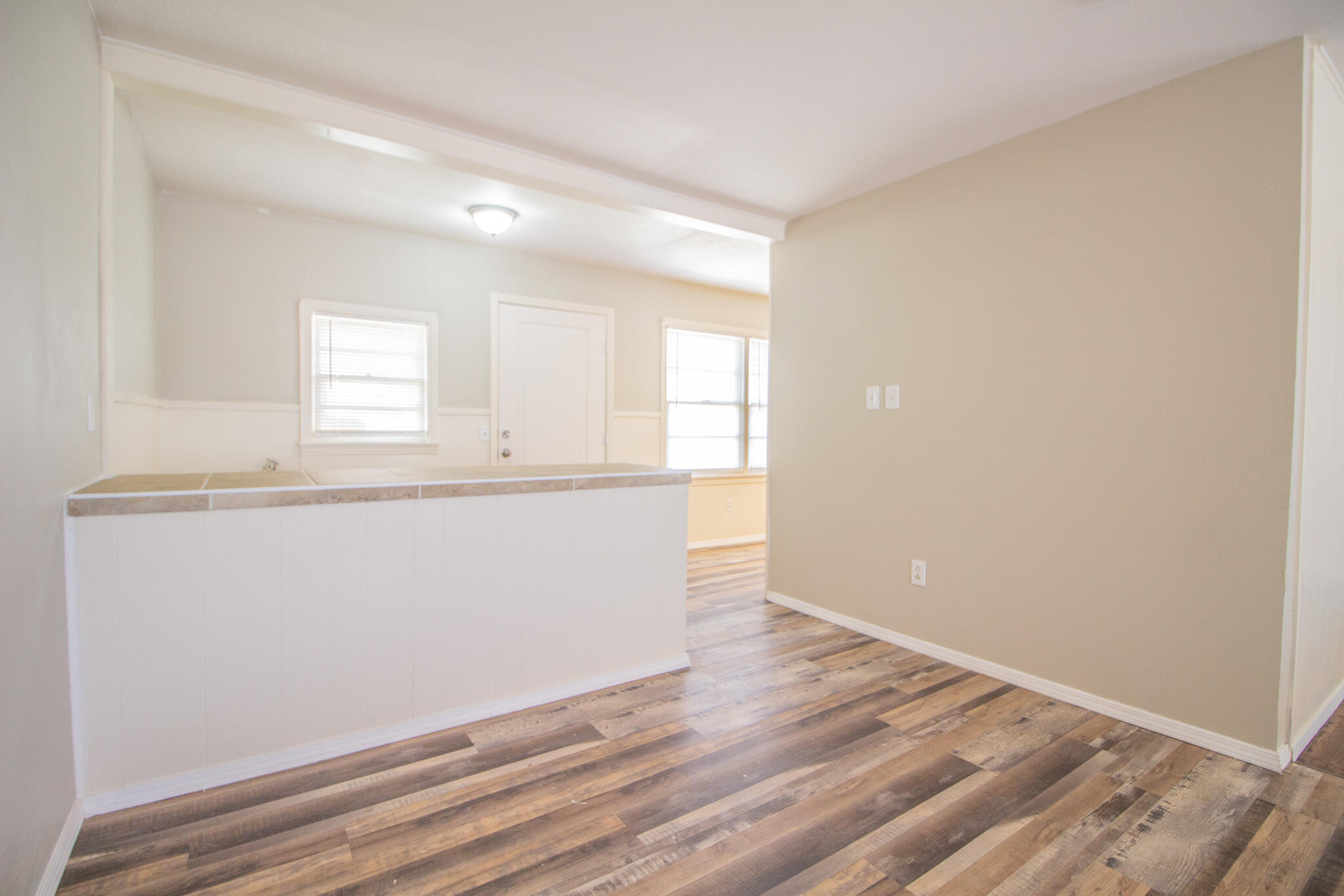 1304 42nd Street Lubbock, TX 79412 - Photo 6 of 17 an empty room with wooden floor and window