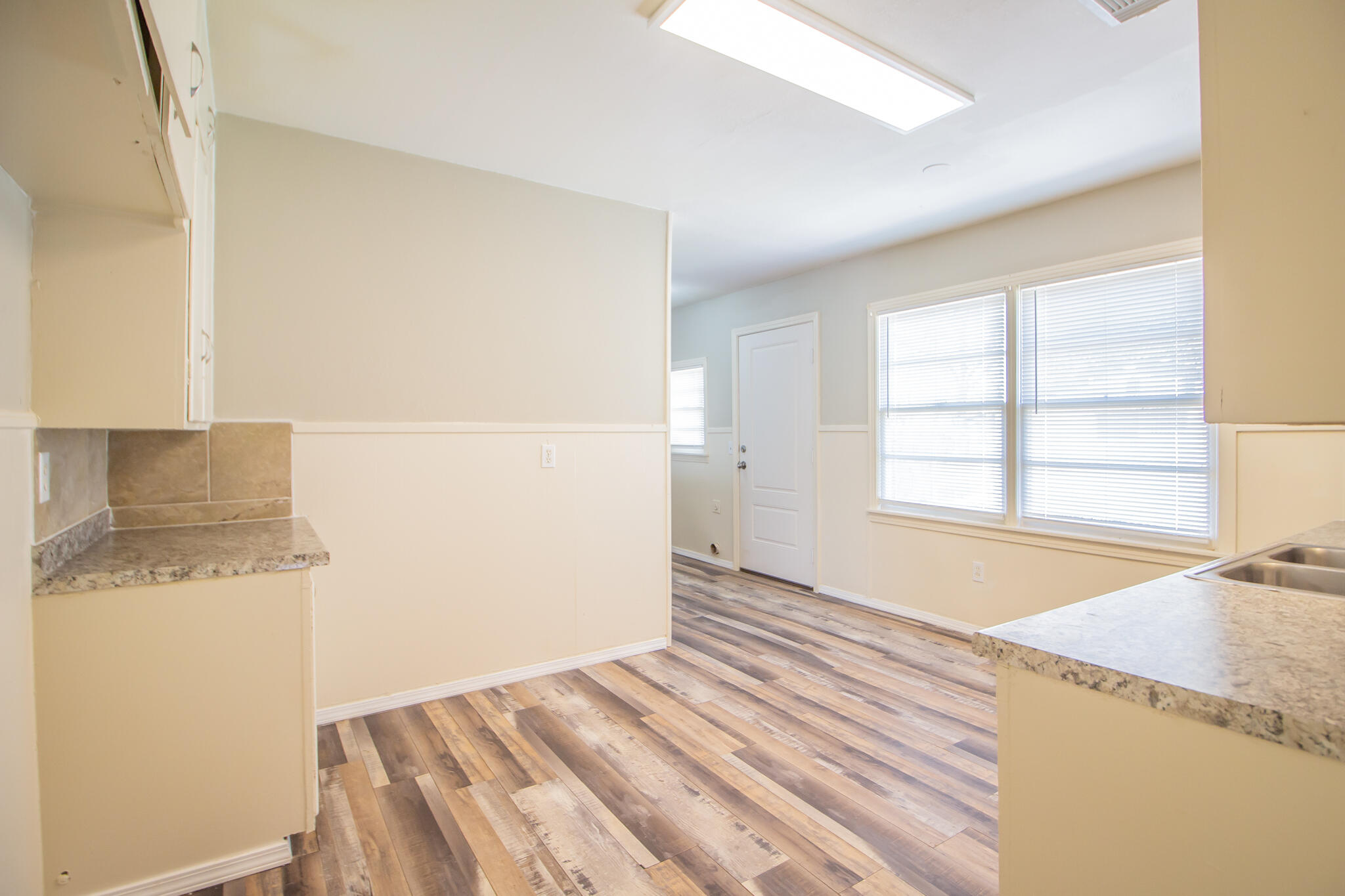 1304 42nd Street Lubbock, TX 79412 - Photo 9 of 17 a view of a bedroom with wooden floor and a sink