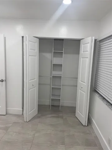 a view of an empty room with a closet