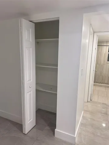 a view of a hallway to rooms and stairs