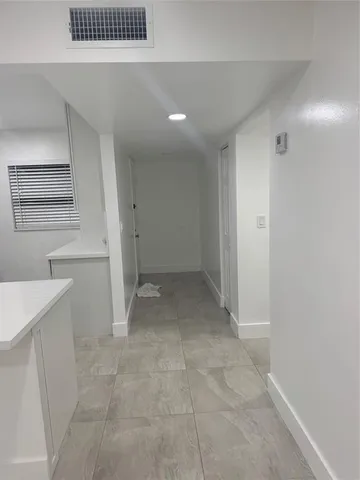 a kitchen with stainless steel appliances a microwave a sink and a refrigerator