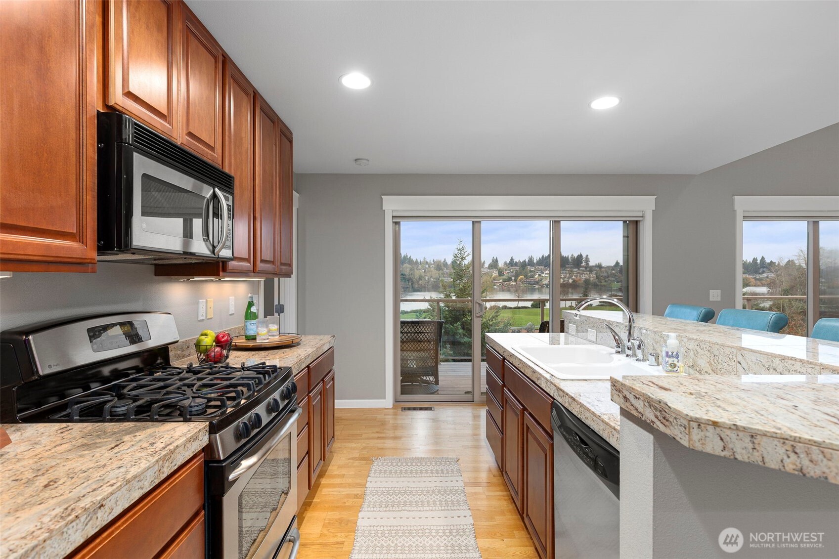 219 Apple Street Bremerton, WA 98310 - Photo 20 of 39 a kitchen with a stove a sink and a wooden cabinets