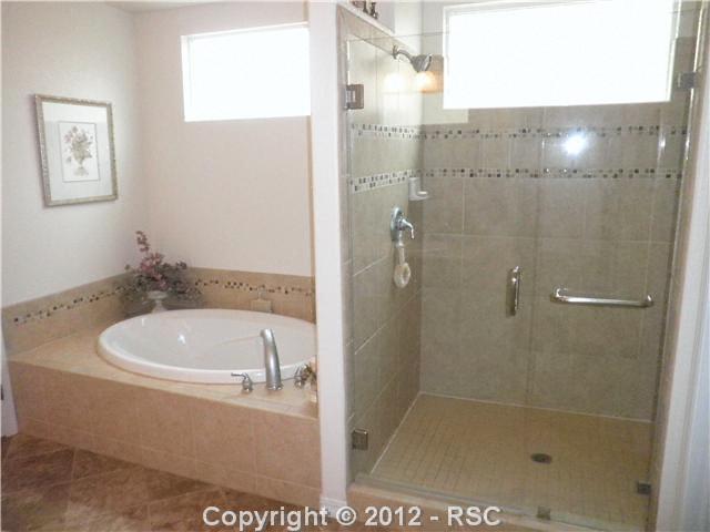 10735 Rhinestone Drive Colorado Springs, CO 80908 - Photo 7 of 16 Master bath with soaking tub and over sized tiled shower