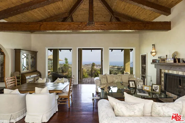 a living room with fireplace furniture and a floor to ceiling window