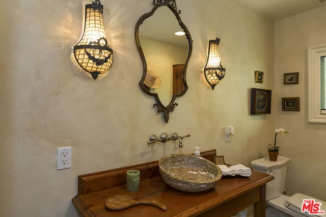 a bathroom with a sink mirror and vanity
