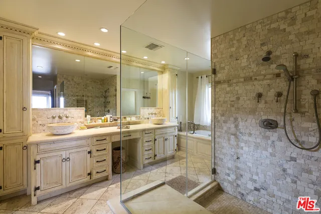 a bathroom with a granite countertop sink mirror and a shower