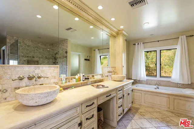 a bathroom with a double vanity sink and a bathtub